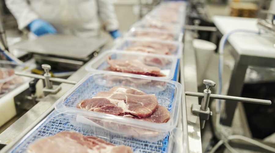 Close up of a meat on a packing machine.